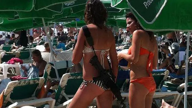 En bikini y con un fusil de asalto en una playa de Israel