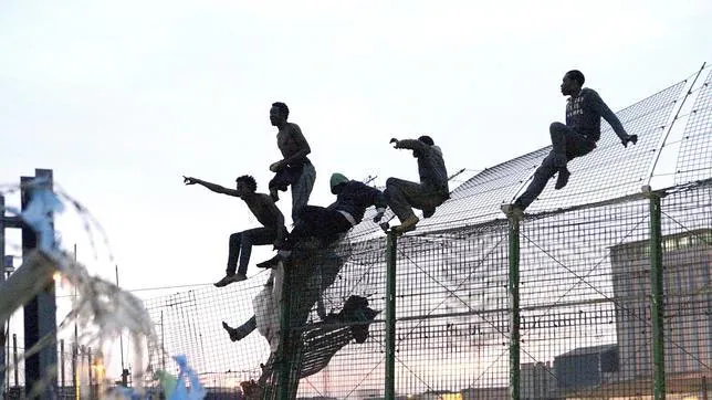 Inmigrantes saltando la valla de Melilla