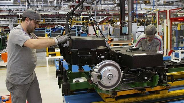 Dos operarios colocan las baterías de la furgoneta eléctrica Citroën planta de PSA en Vigo