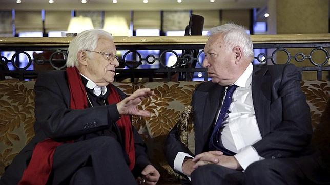 Margallo, a la derecha, conversa ayer en la capital jornada con el padre Ángel, de Mensajeros de la Paz
