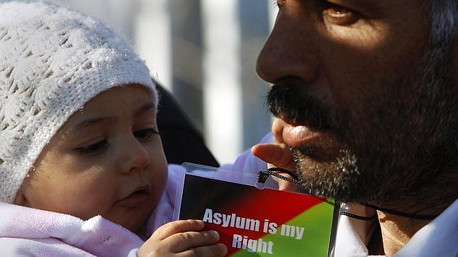 Un refugiado afgano y su hija piden asilo en el Ministerio de Protección griego, en Atenas