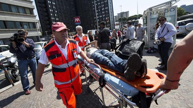 Una mujer herida es trasladada en camilla por miembros de los servicios de rescate tras un accidente de metro en Roma (Italia)