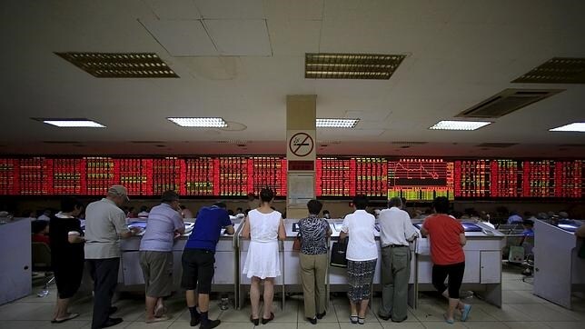 Inversores frente a pantallas de Bolsa en Shanghái