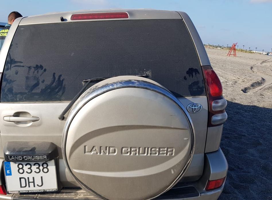 Un agente de la Guardia Civil, junto al vehículo sustraídoy utilizado en este alijo