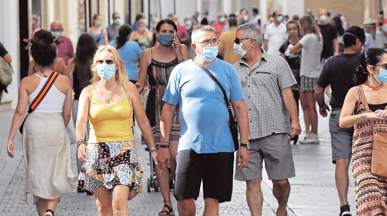 Sevillanos paseando con mascarillas