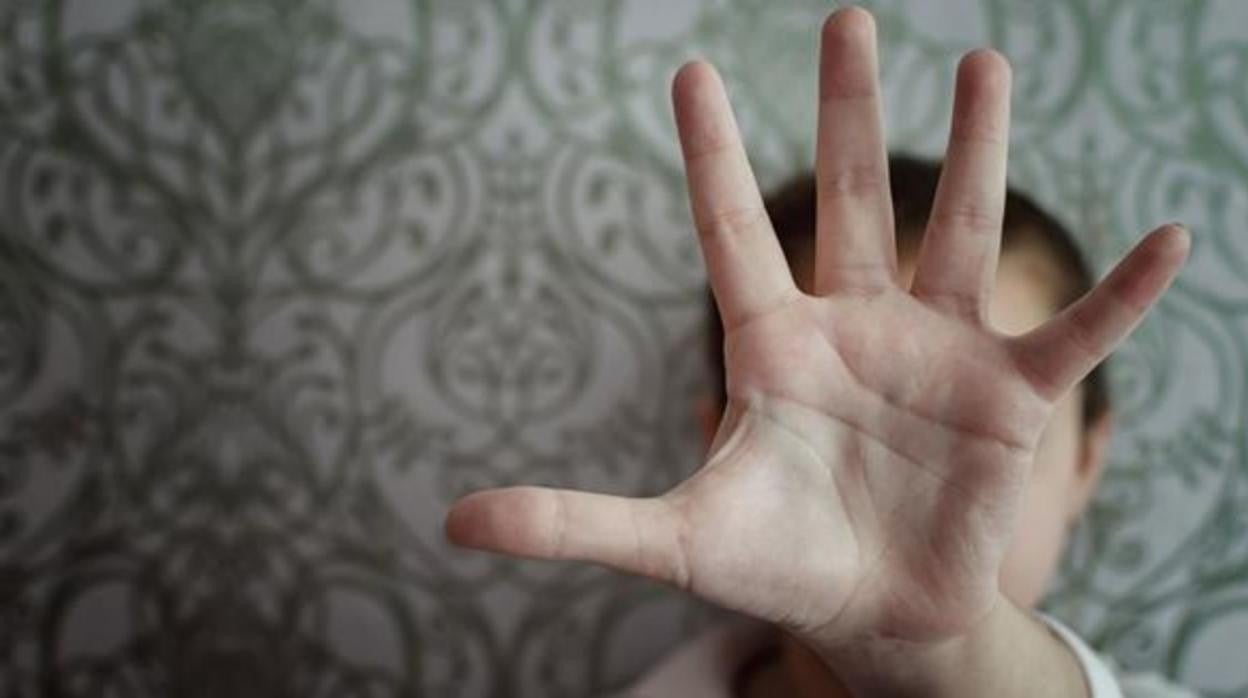 Una menor se protege en una imagen de archivo