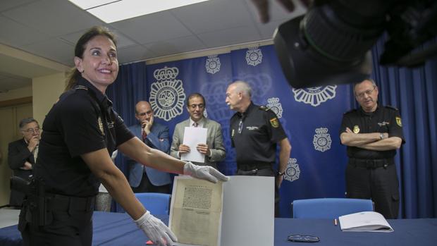 Una portavoz de la Policía muestra el documento ante el rector, el jefe superior y el comisario