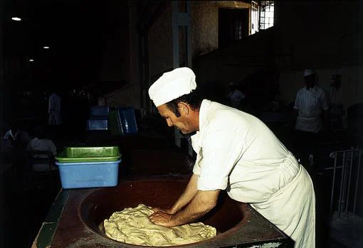 Operario amasando en 1985 la harina con la que se hacían las tortas de Inés Rosales