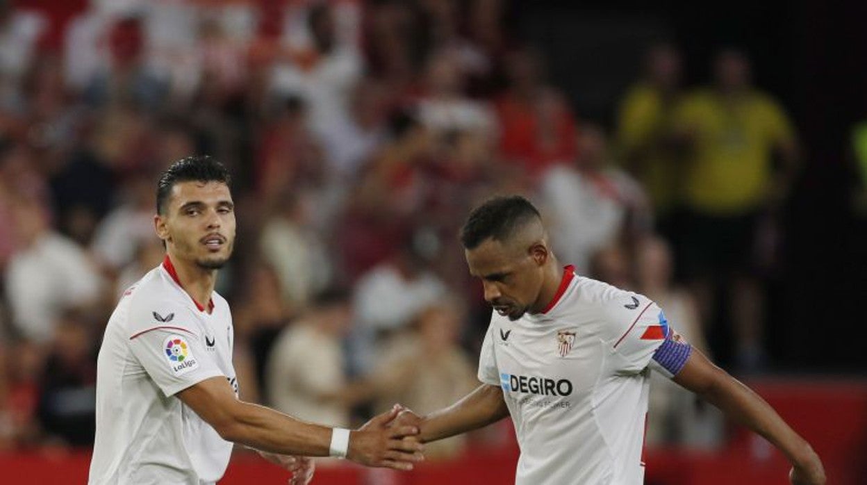 Fernando Reges choca la mano con Karim Rekik tras una acción del Sevilla - Valladolid de la segunda jornada