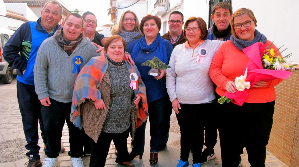 Pepi Díaz, en el centro con el galardón, rodeada de la mayoría de los usuarios de El arte de vivir