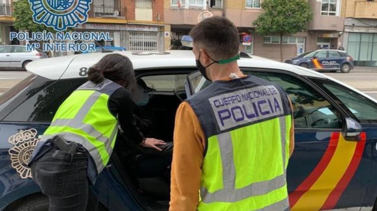 Dos agentes conducen a uno de los detenidos a los juzgados del Prado