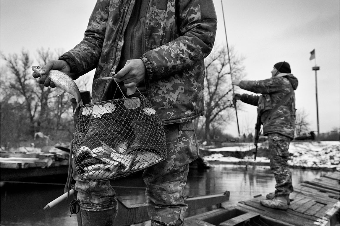 Donbas - Ucrania: Dos soldados pescan en un rio próximo a la linea del frente de Bakhmut.