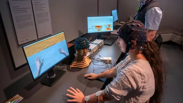 A brain-machine interface for neurological rehabilitation.  A helmet with electrodes captures brain waves which are then processed by a computer