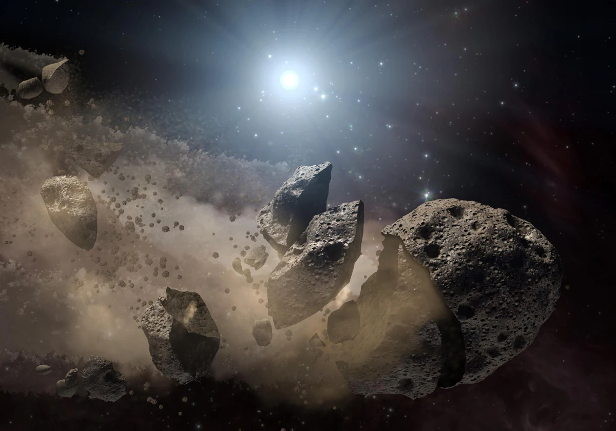 Un asteroide se parte en el espacio, liberando una nube de polvo