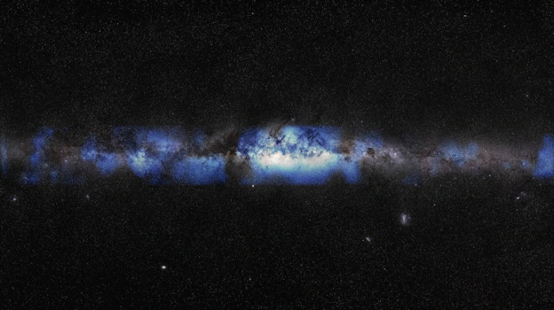 Composite image of a photo of the Milky Way captured in visible light along with the first neutrino-based image of the Milky Way. The detected neutrinos, represented in blue, are shown positioned at their approximate location relative to the more familiar optical view of the Milky Way galaxy.