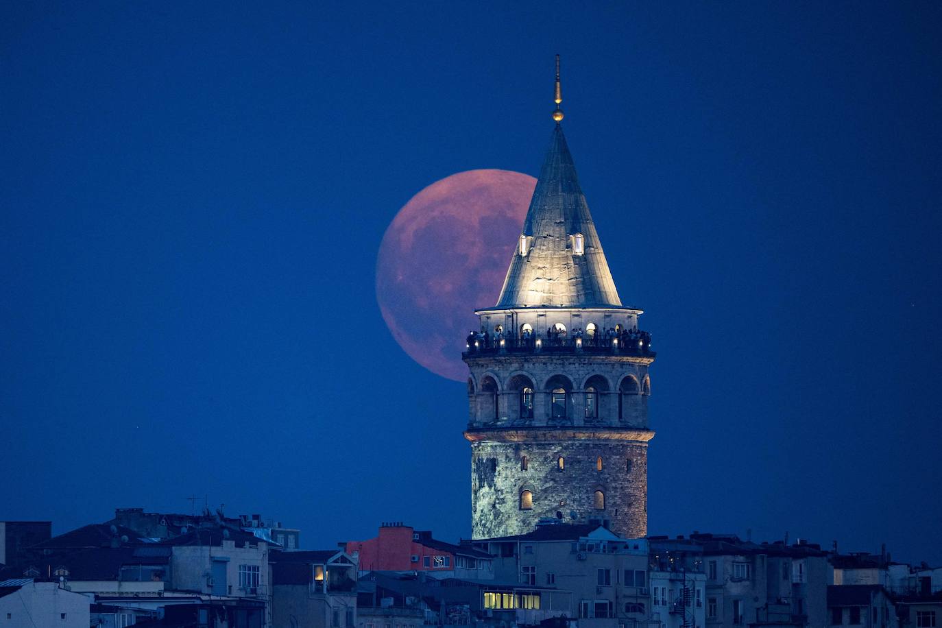 La Superluna Azul sale por detrás de la torre Gálata, en Estambul