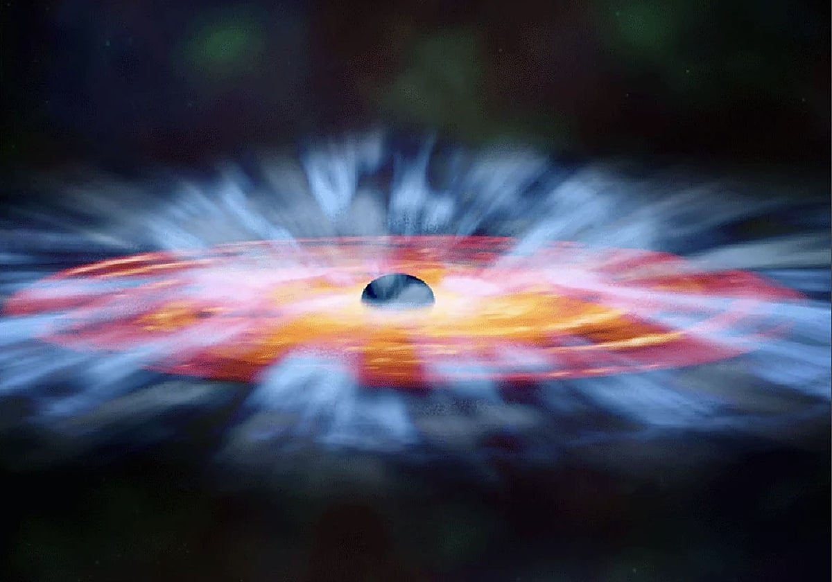 En la ilustración, el 'viento' de radiación de un cuásar (en azul) es lanzado a gran velocidad desde el disco de acreción (rojo y naranja) que rodea a un agujero negro supermasivo