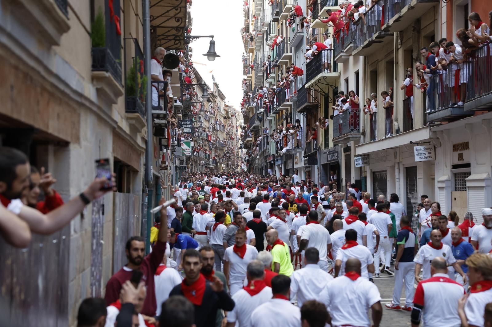 Los corredores esperan la llegada de los astados en  el sexto encierro de San Fermín