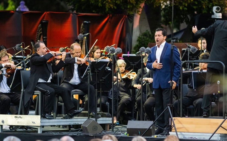 Imagen principal - Jorge León, durante una de sus intervenciones; aspecto general del concierto; y el director, Karel Mark Chichon