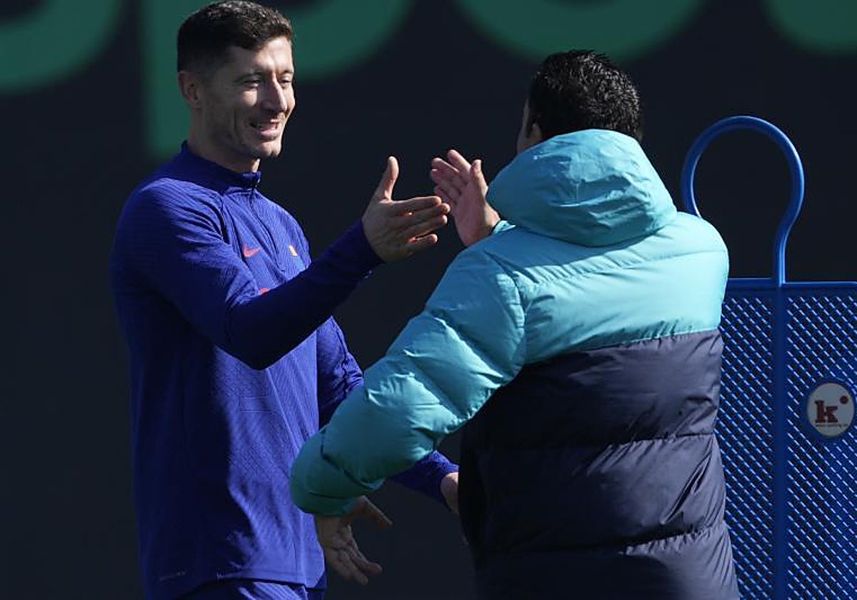 Xavi salud a Lewandowski durante el entrenamiento de este sábado