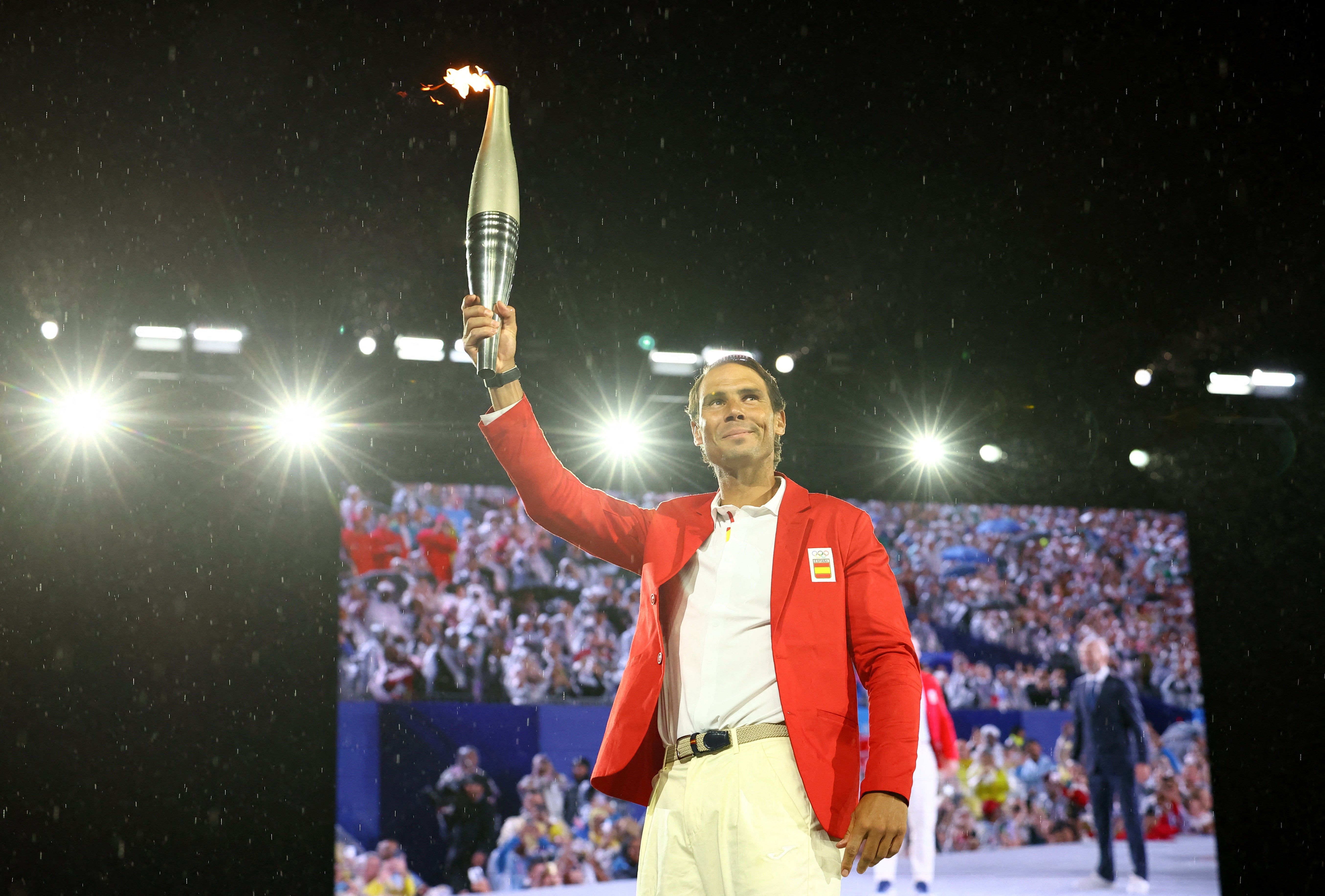 Imagen principal - En su última participación, el español fue el elegido para portar la antorcha desde Trocadero al río Sena durante la apertura de los Juegos. Un homenaje a toda una vida dedicada al deporte