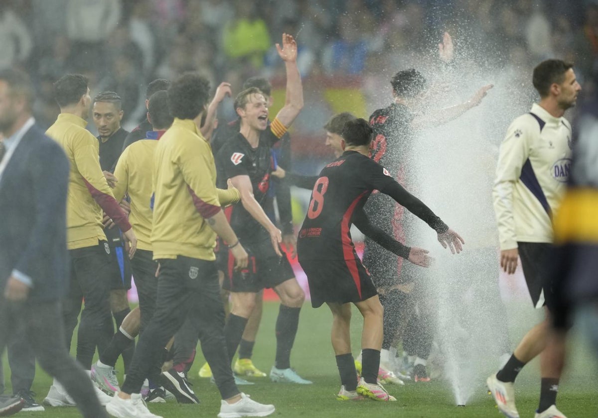 El Barcelona celebra el título entre aspersores