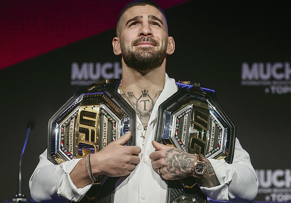 Topuria posa con sus dos títulos de la UFC