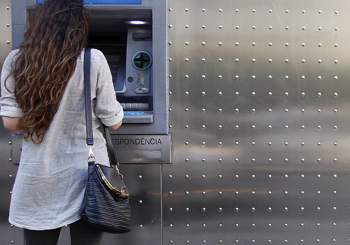 Una mujer sacando dinero del cajero automático