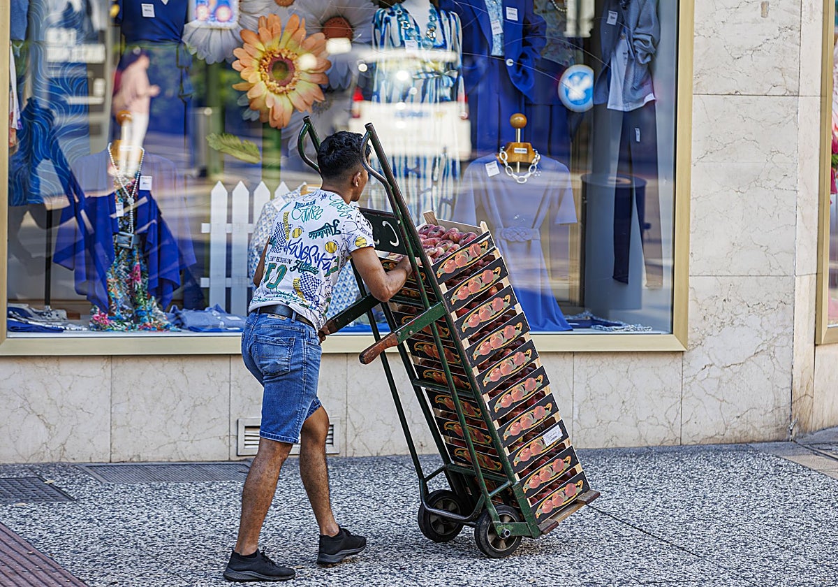 Un trabajador transporte cajas de fruta en Zaragoza