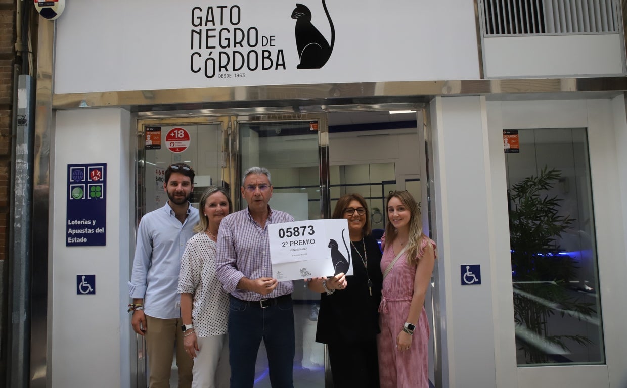 El dueño del Gato Negro, agraciada con el segundo premio, posa con el número