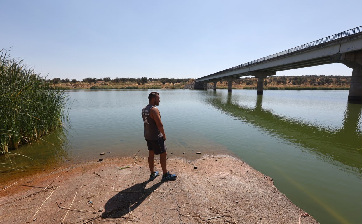 Un joven observa el bajo nivel que presenta el embalse de La Colada