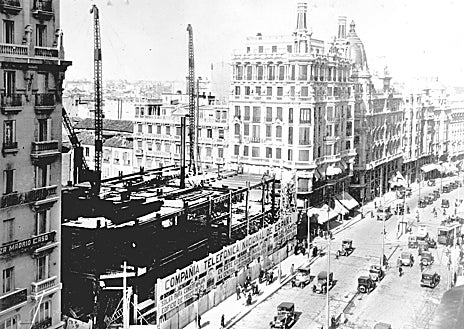 Imagen secundaria 1 - El rey Alfoso XIII contempla las vistas de Madrid desde lo alto del edificio Telefónica (arriba). Abajo, dos imágenes de la construcción del rascacielos, entre 1927 y 1929. 