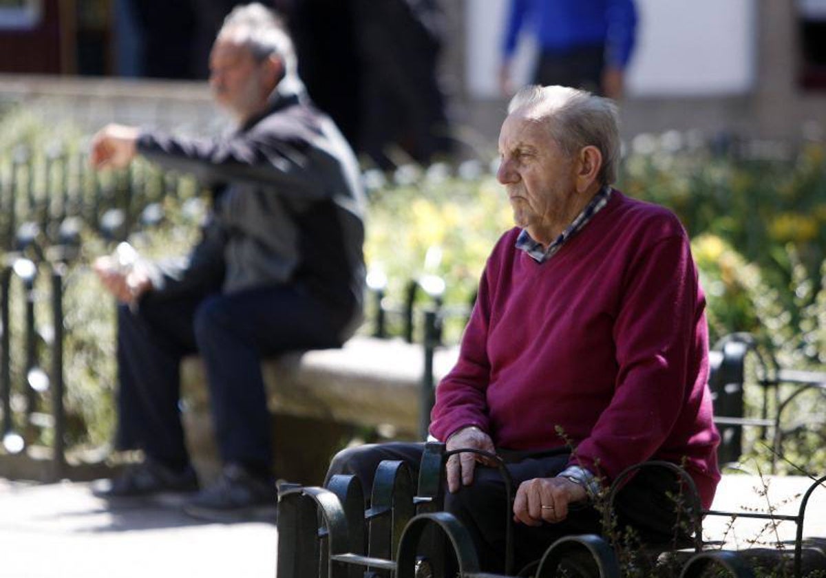 Dos personas descansan en un parque, en una imagen de archivo