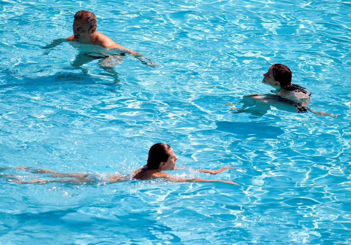 Unos bañistas disfrutan en una piscina pública