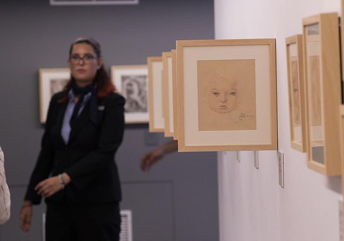 Dibujos de Miguel Abad en la exposición del Mubag, con una visitante al fondo.