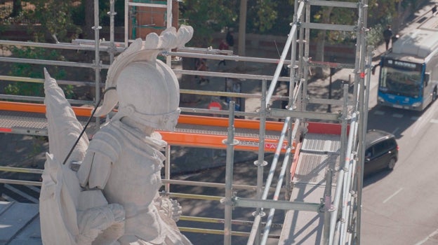 Imagen después - Una de las panoplias o conjuntos de armas, en la fachada oeste de la Puerta de Alcalá, antes y después de su intervención. Los restauradores han limpiado la piedra ennegrecida y reforzado la escultura con nuevas grapas metálicas, forjadas con hierro del siglo XVIII.