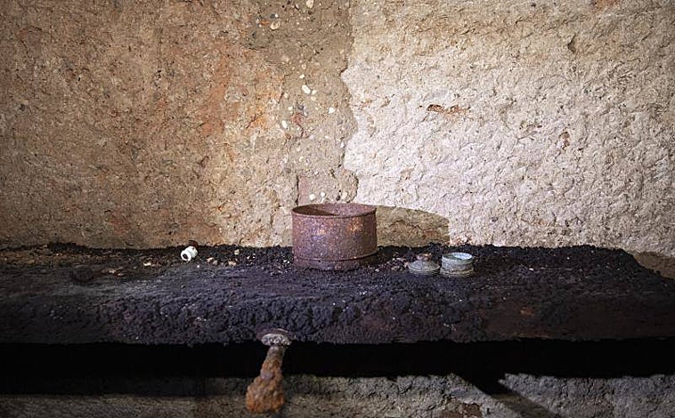 Imagen principal - Arriba, una balda primitiva en el refugio, que aún conserva una lata y algunos proyectiles. Abajo, dcha, puerta de acceso, izquierda una de las tres salas de que se compone el refugio: las paredes están hechas con sillares de una cercana iglesia.
