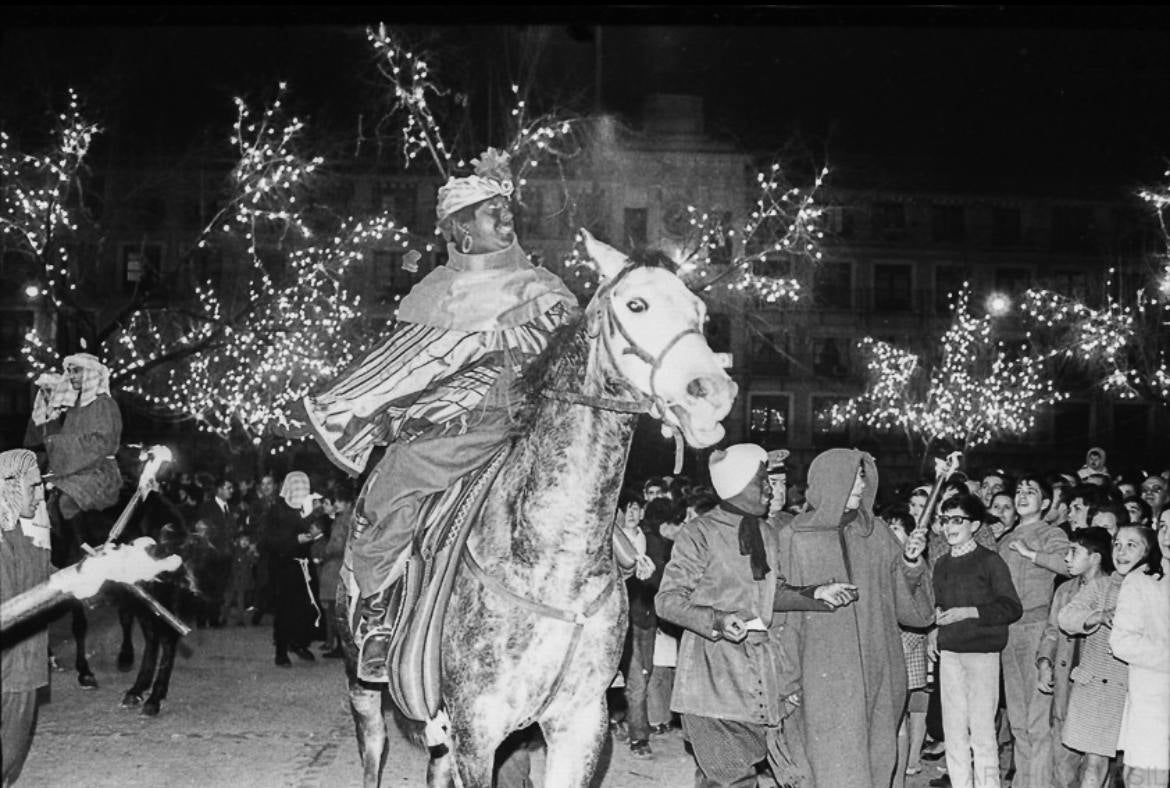 Los Magos sobre sus cabalgaduras acompañados de sus séquitos con bengalas se encaminan desde Zocodover hacia la calle del Comercio el miércoles 5 enero de 1972. Foto de María Teresa Silva Hernández. Archivo VASIL