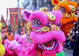 Una multitud vitorea al dragón en las calles de Usera en el arranque del Año Nuevo chino