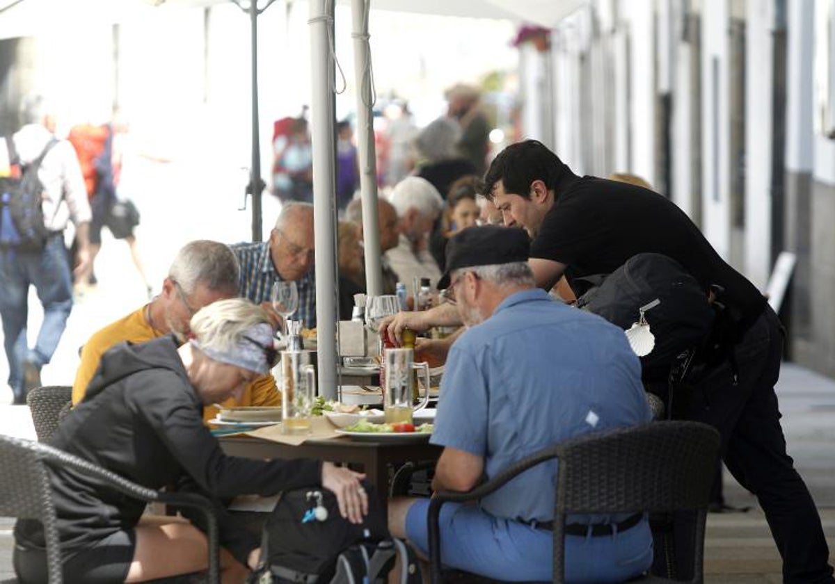 Un hostelero atiende a sus clientes en un bar de Santiago de Compostela