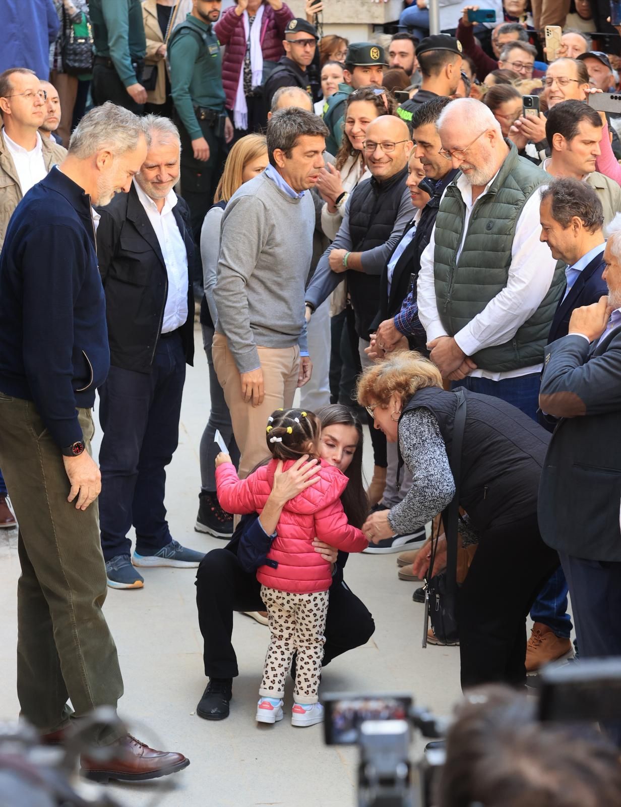 Letizia abraza una niña en Chiva ante la presencia de Felipe VI y Mazón