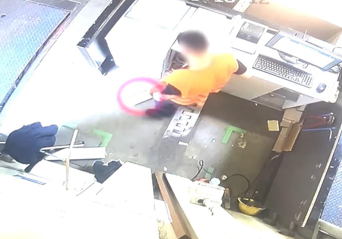 El trabajador escondiendo la caja de un teléfono móvil bajo el mostrador