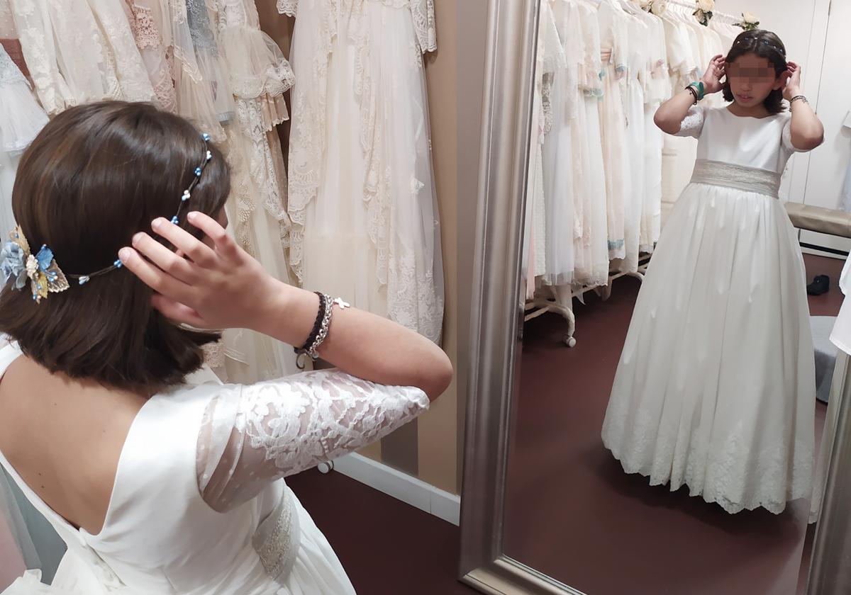 Una niña se prueba su vestido de comunón