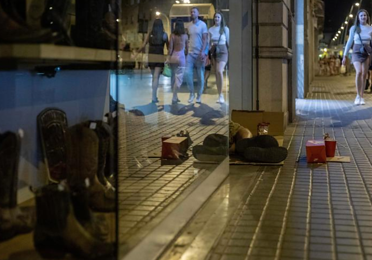 Una persona sin hogar pernocta en la calle en foto de archivo