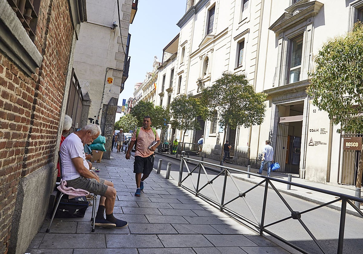 Personas sin techo, mendigos y excluídos, junto a la iglesia de San Antón, en la calle de Hortaleza
