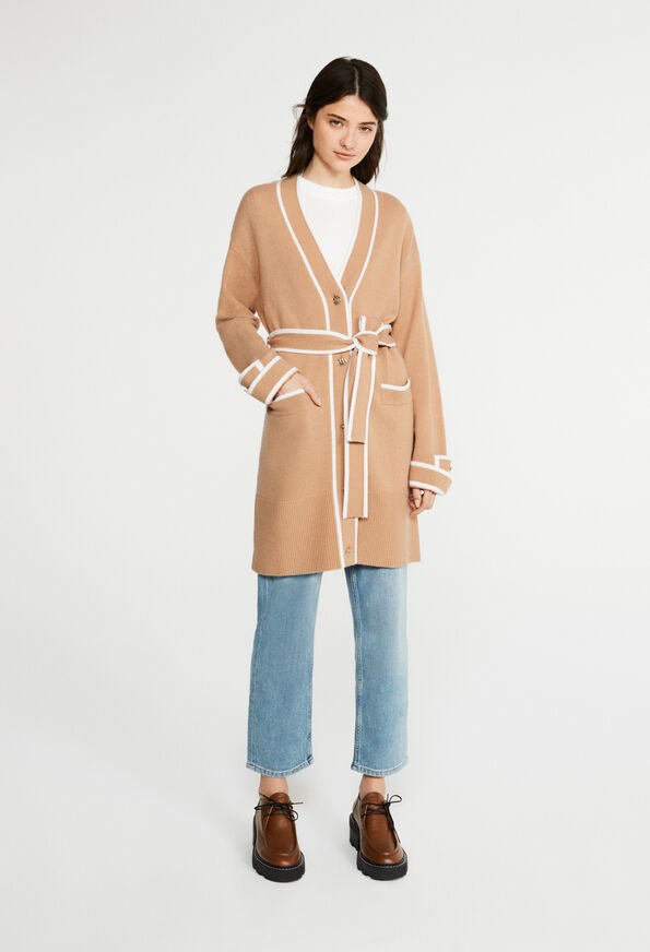 Cárdigan largo de lana trenzable en color cámel con ribetes blancos: 285 euros en Claudie Pierlot.