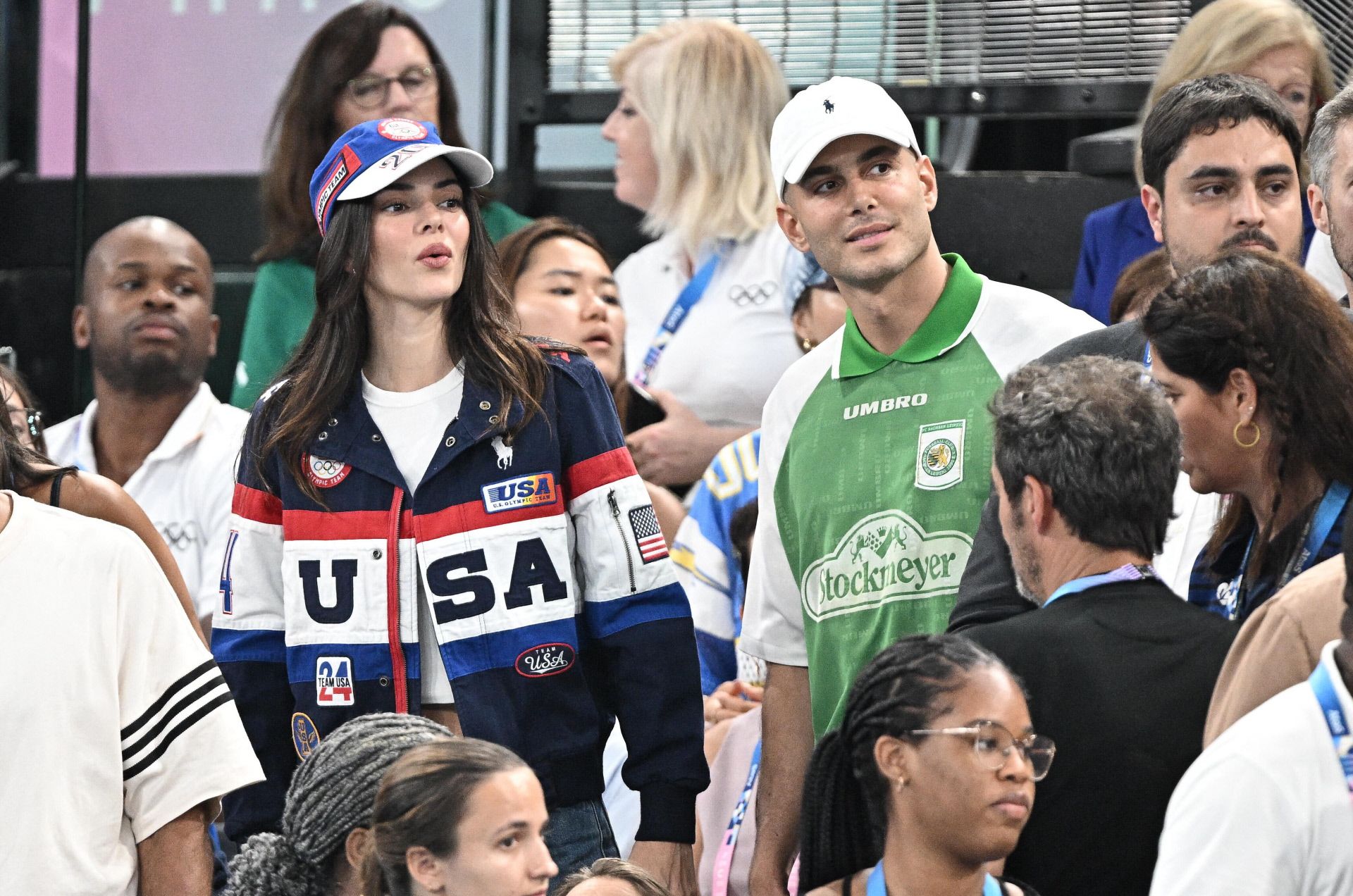 Kendall Jenner se dejó ver en los Juegos Olímpicos con un look deportivo, formado por unos jeans, una camiseta blanca básica, la cazadora bomber del equipo oficial de Estados Unidos y gorra. 