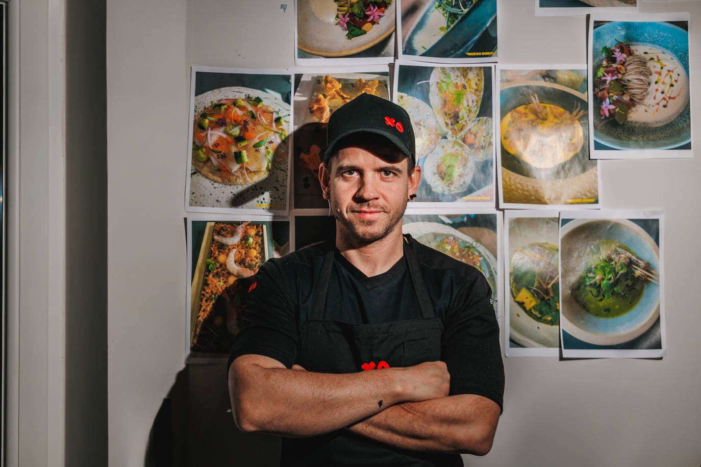 Dabiz Muñoz posa ante una de las paredes del estudio, con imágenes impresas de platos