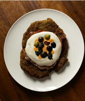 Secondary image 2 - Dante Liporace with his pizza in a glass; the Dantte façade and its veal Milanese.