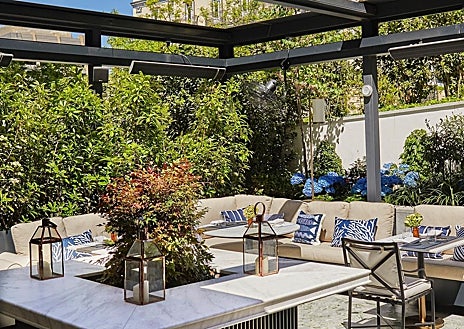 Imagen secundaria 1 - La sala y la terraza de Amós, en Madrid, y el chef Jesús Sánchez en su panadería de Cantabria.